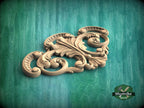 a wood carving of an ornate design on a green background