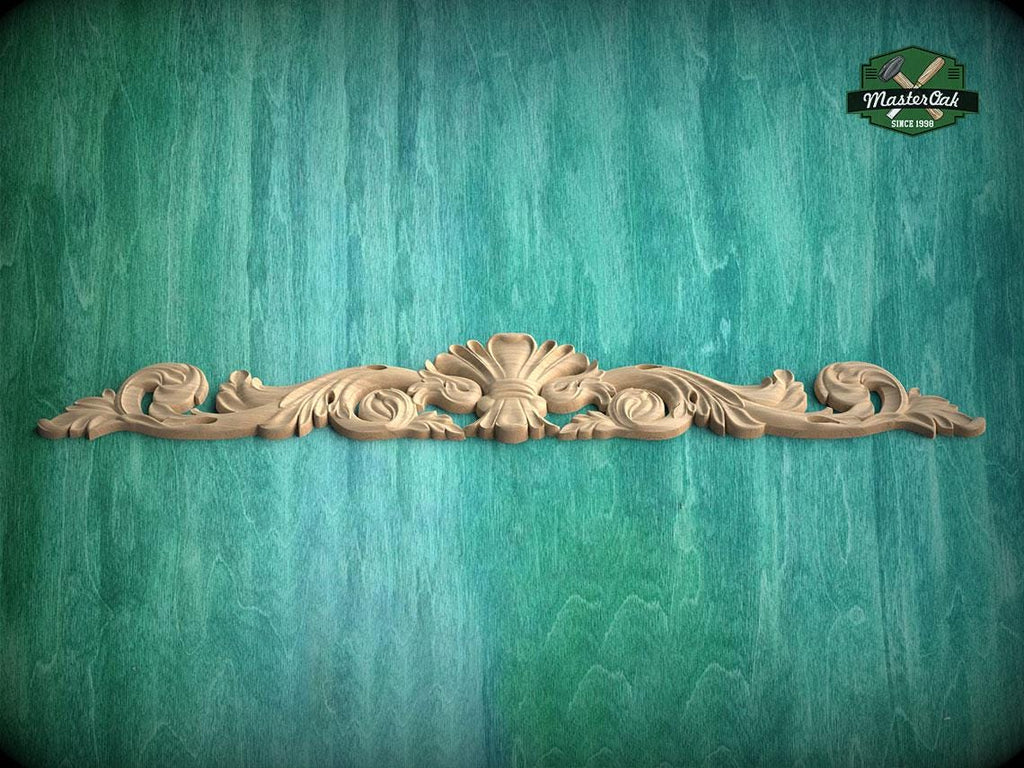 A decorative wooden carving with intricate scrollwork is displayed against a textured green background.