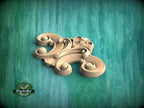 A wooden carving of an ornate, swirling design is displayed against a green background.
