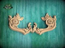 Load image into Gallery viewer, two ornate wooden handles with intricate carvings, displayed against a green textured background.
