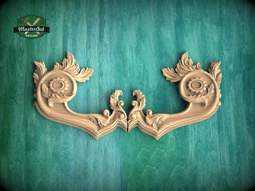 two ornate wooden handles with intricate carvings, displayed against a green textured background.