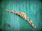 a wooden carving of a flower on a green background