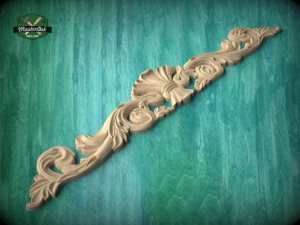 A decorative wooden carving with intricate floral and scrollwork designs is displayed against a green textured background.