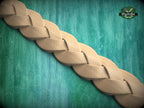 A wooden braided pattern is displayed against a green background.