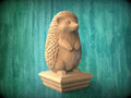 A wooden hedgehog statue stands on a pedestal against a green background.