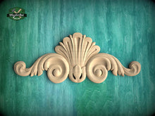 Load image into Gallery viewer, a decorative wooden carving on a teal background.
