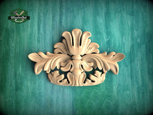 a decorative wooden carving on a green background.