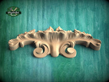 Load image into Gallery viewer, A wooden carving with intricate scrollwork is displayed against a green background.
