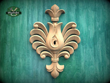 Load image into Gallery viewer, a decorative wooden carving on a green background.
