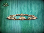 A decorative wooden frame with intricate scrollwork is displayed against a textured green background.
