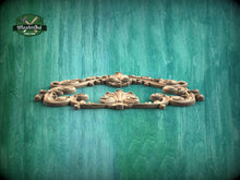Load image into Gallery viewer, A decorative wooden frame with intricate scrollwork is displayed against a textured green background.

