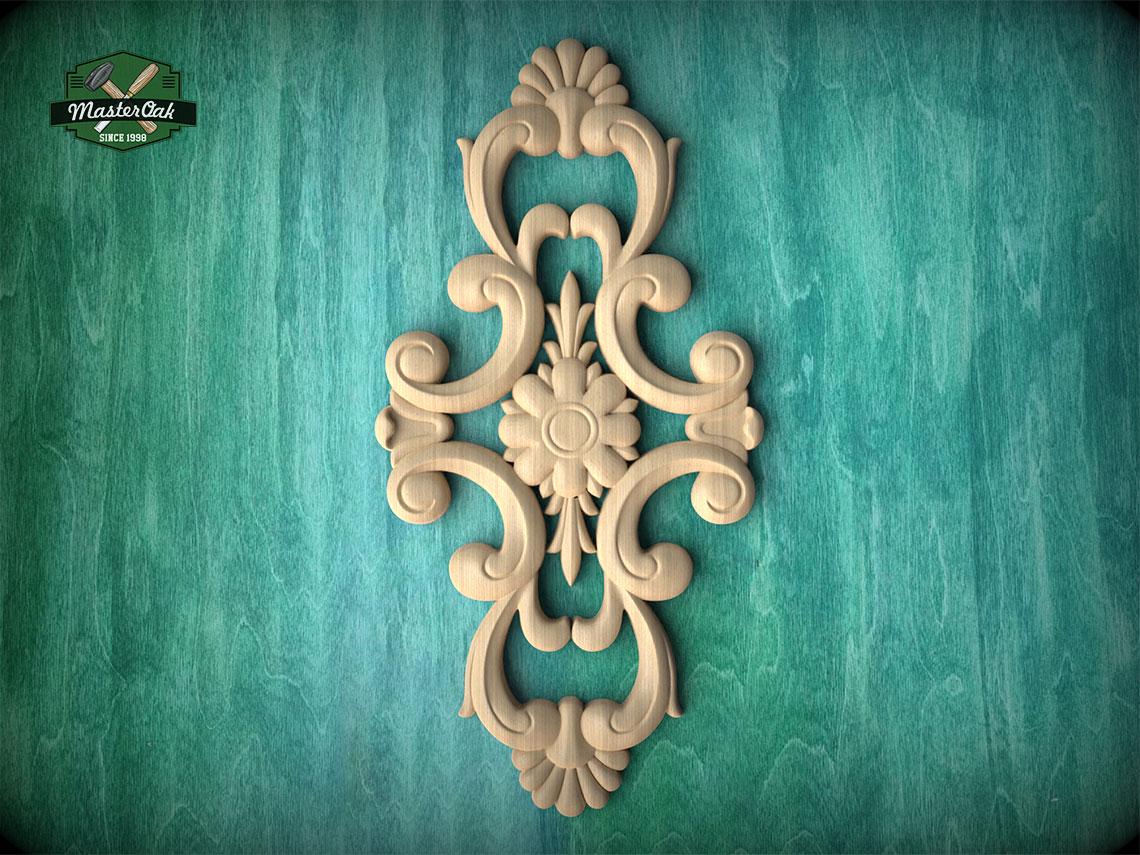 an ornate, carved wooden design with intricate scrollwork and floral elements, set against a green textured background.