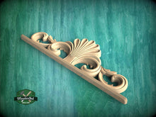 Load image into Gallery viewer, A decorative wooden carving with an intricate, ornate design is displayed against a teal-colored background.
