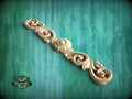 a wood carving of a decorative design on a green background