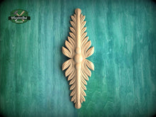 Load image into Gallery viewer, A decorative wooden leaf-like object is displayed against a green textured background.
