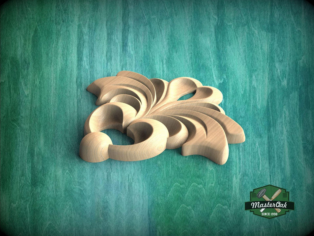 A wooden carving of a stylized flower or leaf design is displayed against a green background.