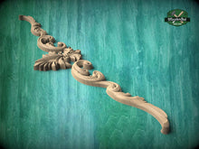Load image into Gallery viewer, A decorative wooden carving with intricate scrollwork is displayed against a teal background.
