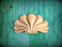 Load image into Gallery viewer, A wooden shell-shaped object is displayed against a green background.
