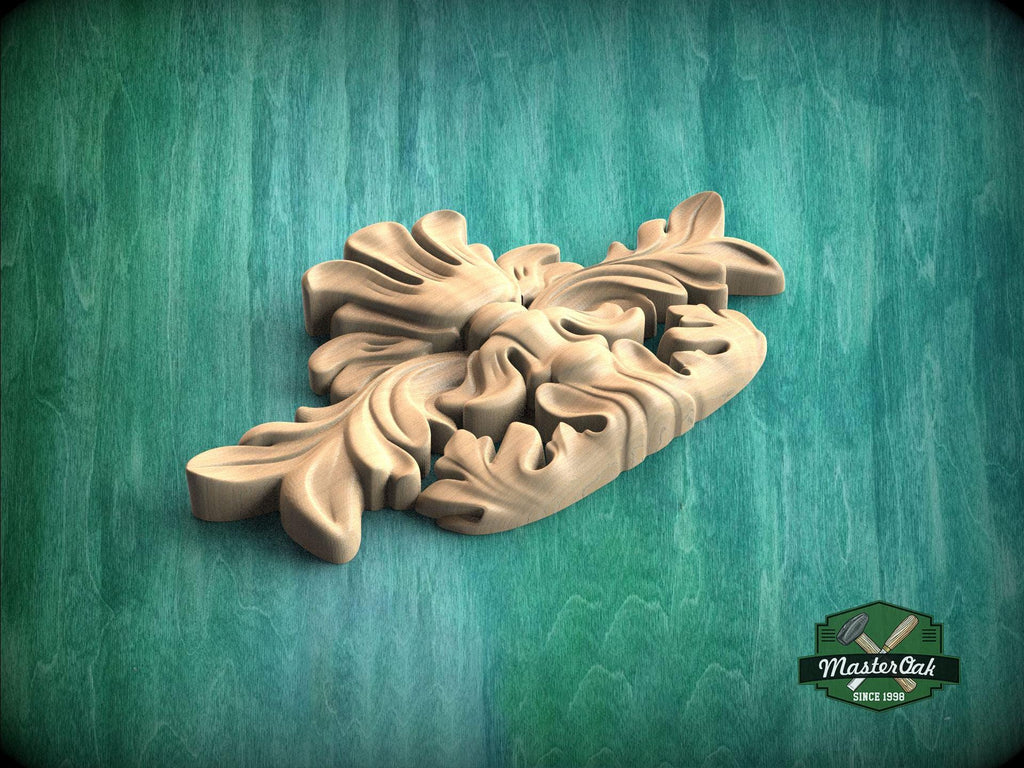 A wooden carving of a leaf-like design is displayed against a green background.