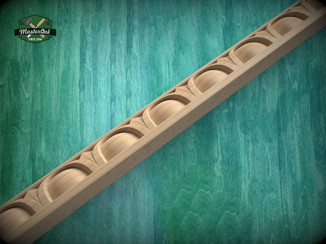 A wooden decorative trim with a curved design is displayed against a green textured background.