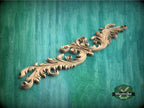 a wood carving of a flower on a green background