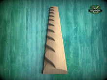 Load image into Gallery viewer, A wooden carving with a zigzag pattern is displayed against a teal-colored background.
