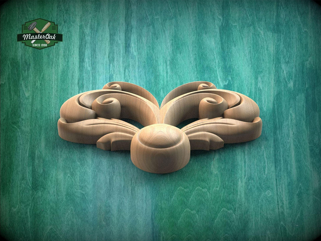 A wooden carving of a stylized flower or leaf design is displayed against a green background.