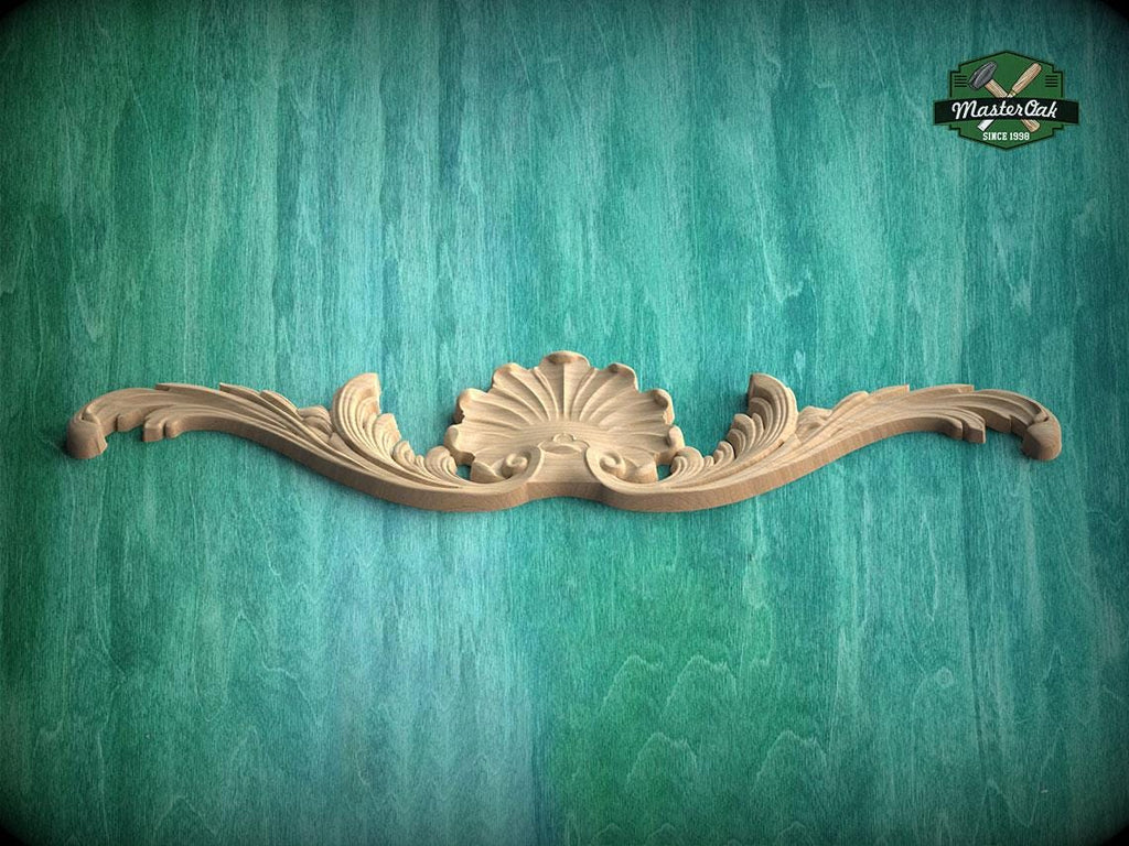 A decorative wooden carving with a shell-like design is displayed against a teal-colored background.