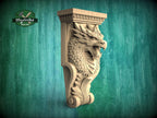 A carved wooden dragon head with a fierce expression is displayed against a green background.