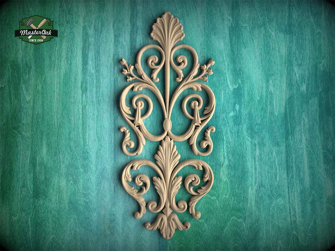 an ornate, decorative carving of a floral design on a teal background.