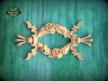 Load image into Gallery viewer, A decorative wooden frame with intricate floral designs, including roses and leaves, is displayed against a green background.
