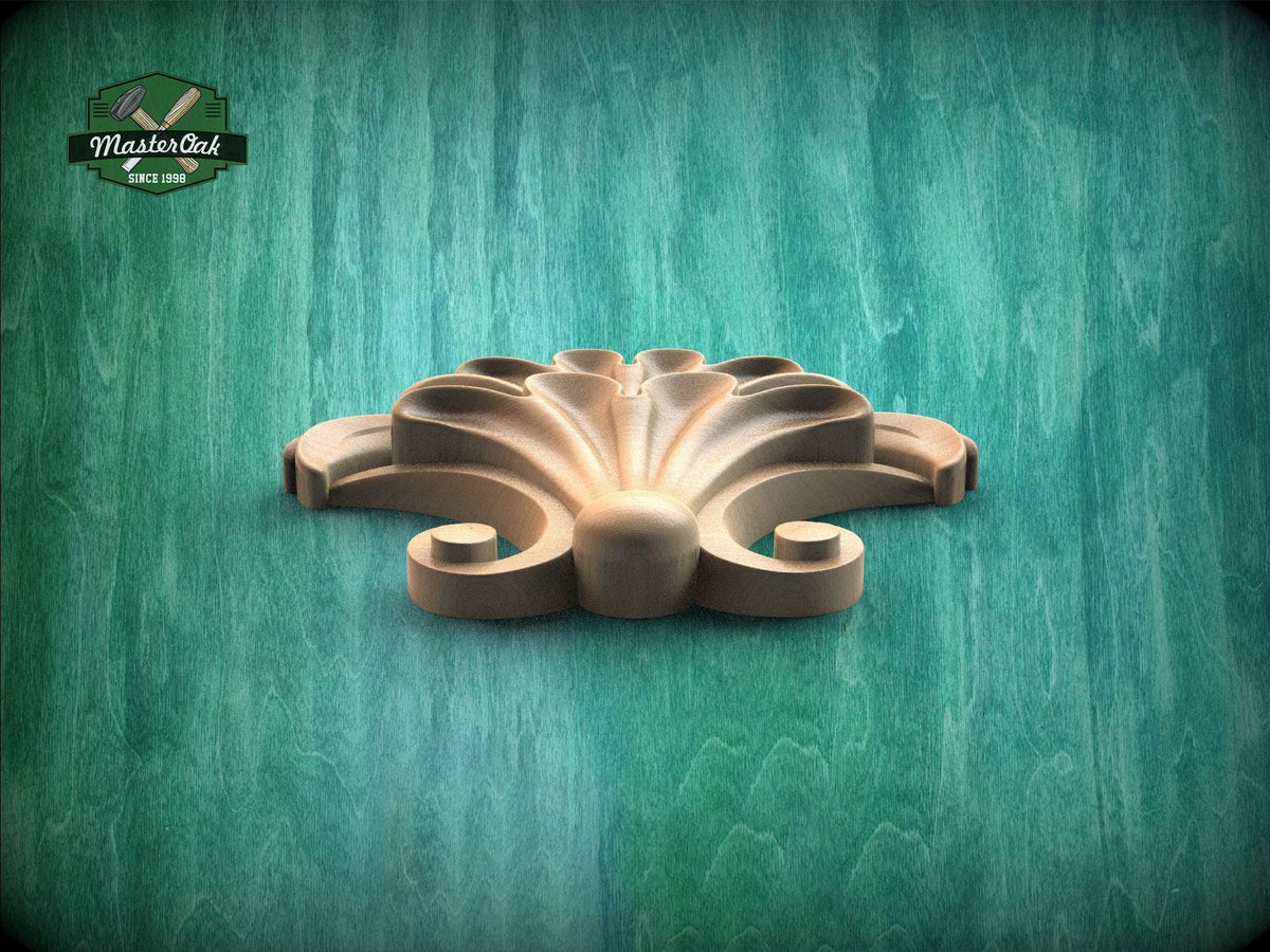 A wooden ornamental piece with a curved, organic design sits on a green wooden surface.