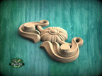 A wooden carving of a flower-like design is displayed against a teal background.