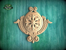 Load image into Gallery viewer, a beautifully carved wooden piece with a floral design, set against a green background.
