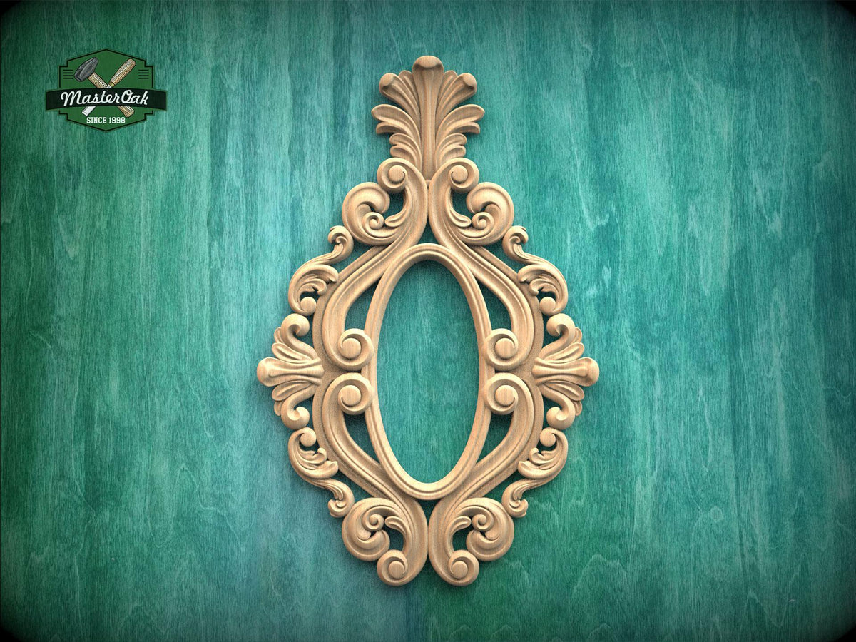 an ornate, carved wooden frame with an intricate, decorative design on a green background.