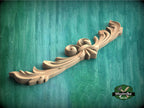 a wood carving of a flower on a green background