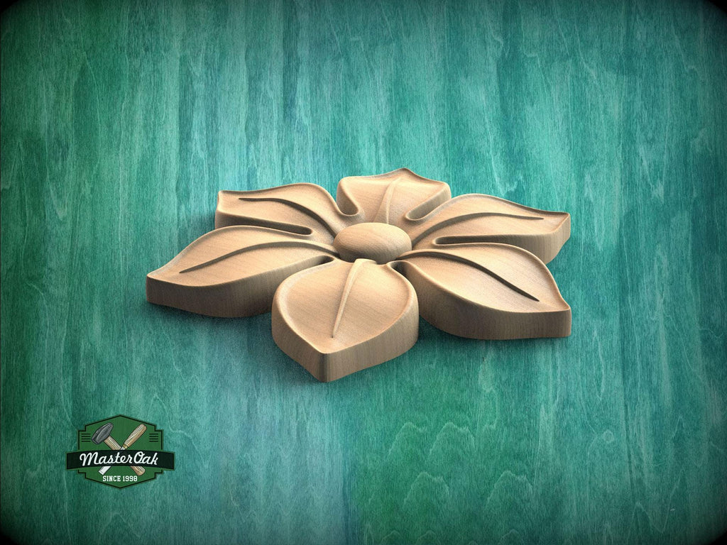 A wooden flower carving is displayed against a green background.