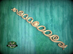a decorative scrollwork piece with a green background.