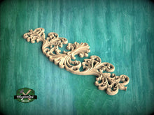 Load image into Gallery viewer, A decorative wooden carving with intricate scrollwork is displayed against a teal background.
