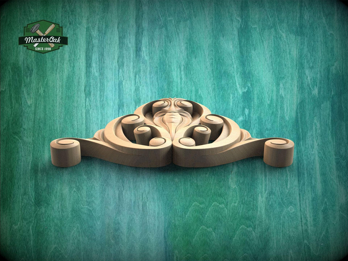 A wooden carving of a stylized face is displayed against a teal-colored background.