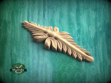 Load image into Gallery viewer, A wooden carving of a leaf-like design is displayed against a green background.
