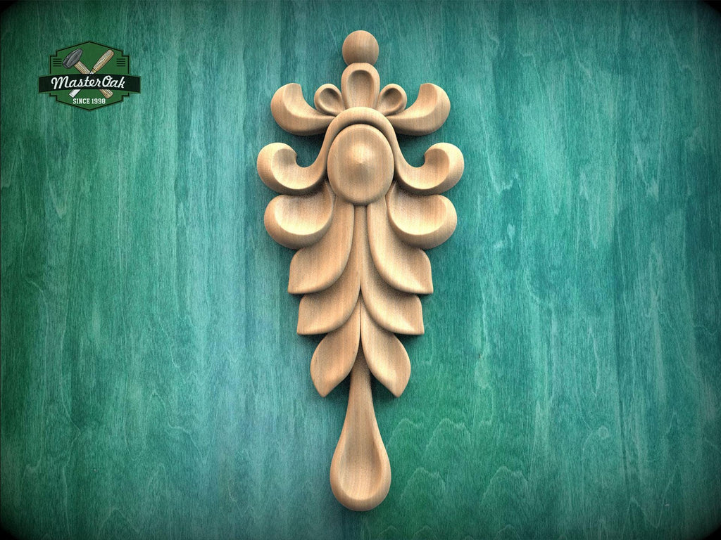 A decorative wooden carving of a leaf-like design is displayed against a green textured background.