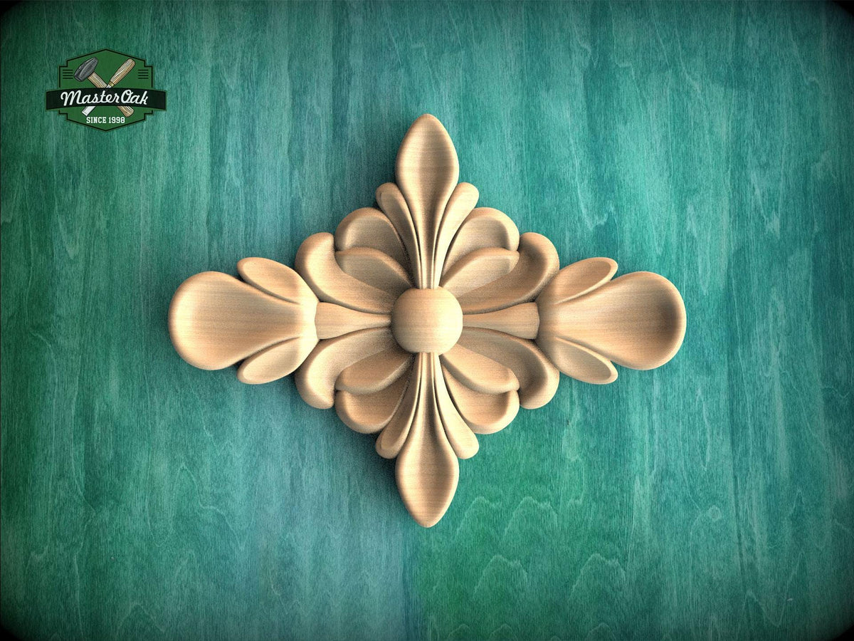 a decorative wooden piece with a floral design, placed against a green background.