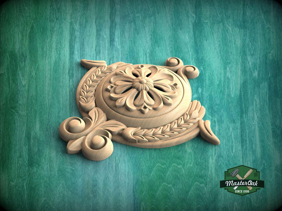 A carved wooden piece with an intricate floral design sits on a green wooden surface.