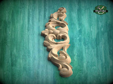 Load image into Gallery viewer, a decorative wooden carving on a green background.
