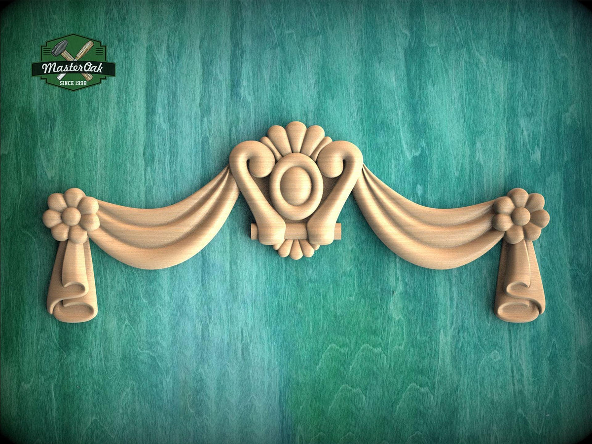 A decorative wooden panel with a floral motif and scrollwork, mounted on a green textured wall.