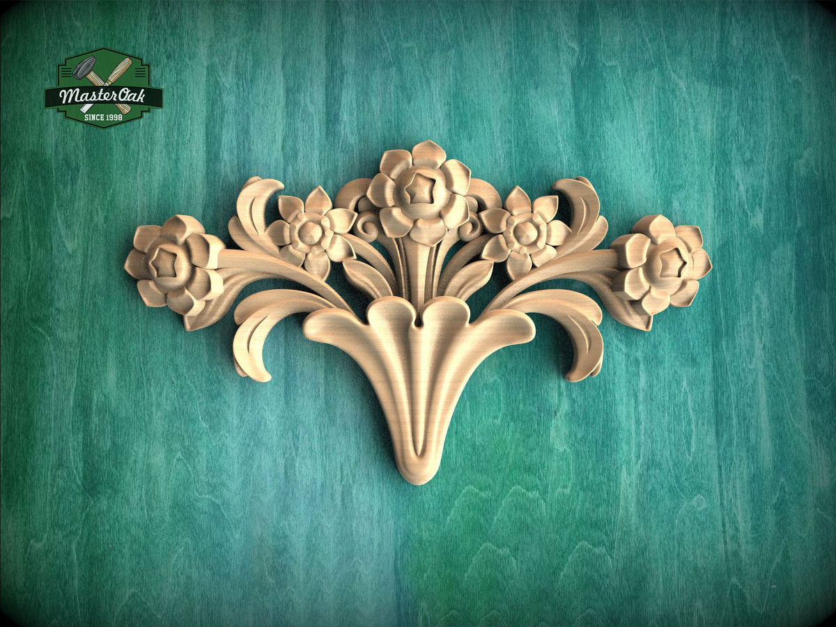 A decorative wooden carving of a flower on a green background.