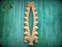 Load image into Gallery viewer, a decorative wooden leaf-like design with a vertical, symmetrical shape, mounted on a green textured background.
