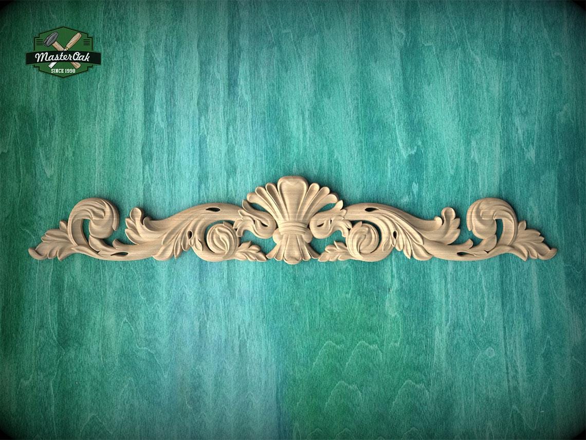 a decorative wooden carving on a green textured background.