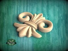 Load image into Gallery viewer, a wood carving of a flower on a green background
